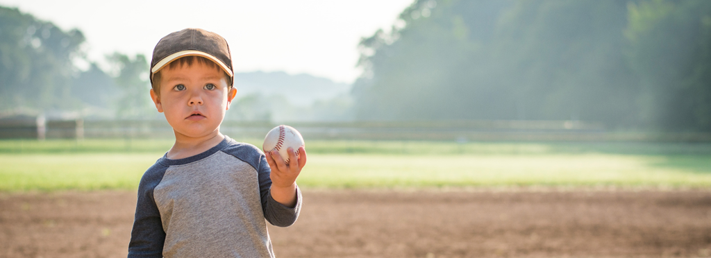 Child holding a baseball